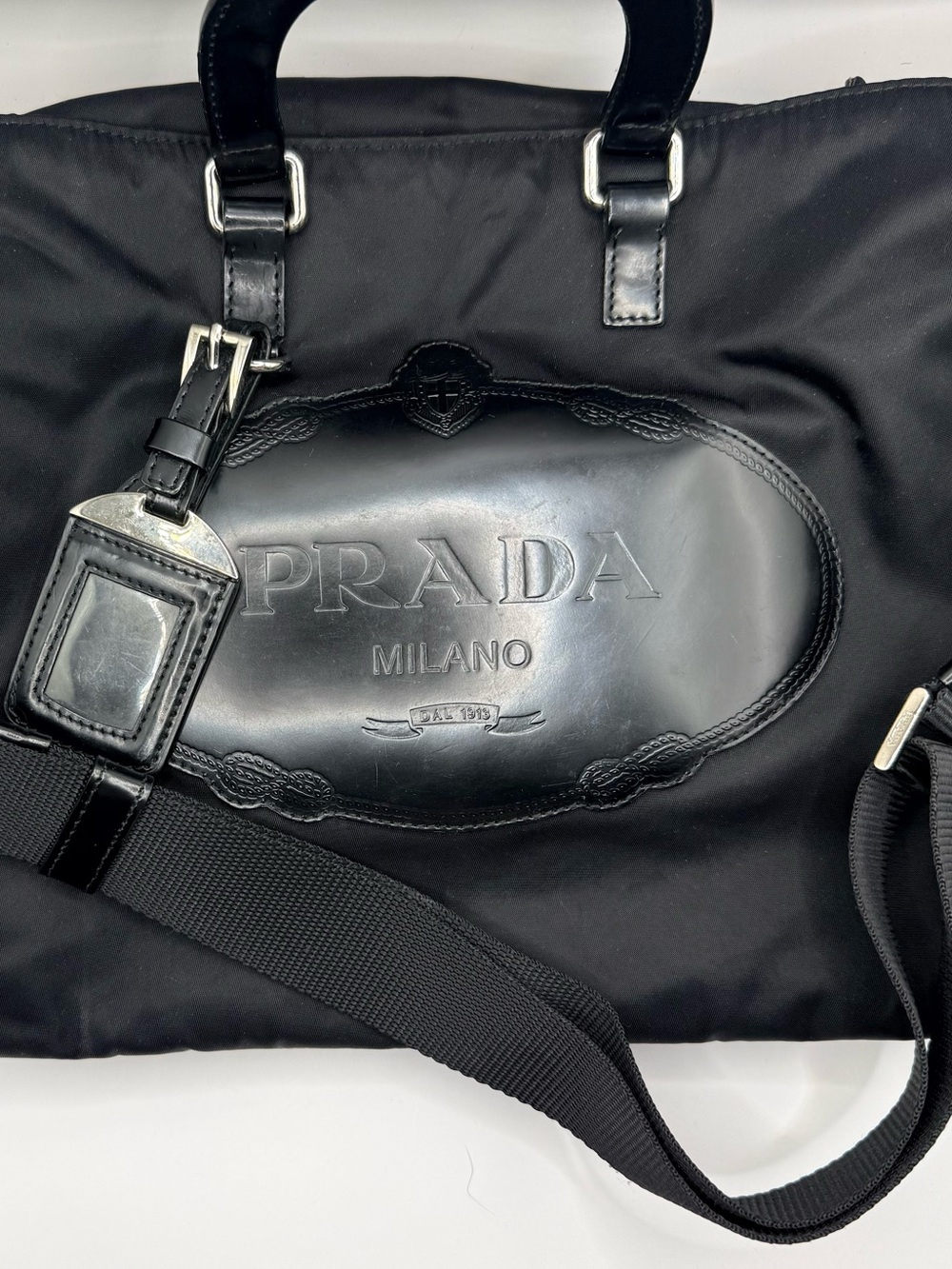 Prada Black Nylon & Leather Bag with Embossed Prada logo.